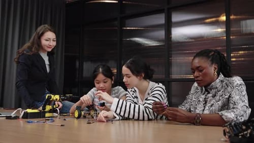Girls and Women Building Robotics Project Together