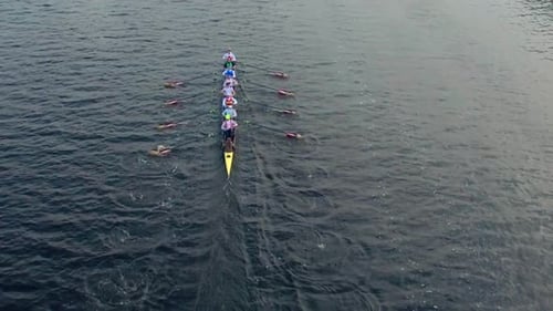Rowing Sport Team away in Slow Motion in Regatta Competition shot with Aerial Drone