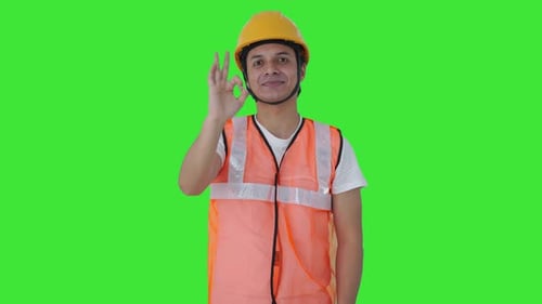 Happy Indian construction labour showing okay sign Green screen