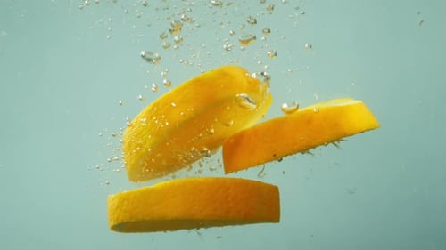 Lemon Slices Falling into Water