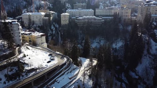 Aerial Drone Shot of an old City in the Mountains covered in Snow