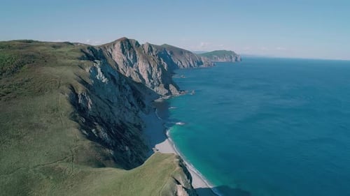 Aerial Panoramic View of the Rocky Cliffs Seaside and Waves are Crashing to the Coast Beautiful