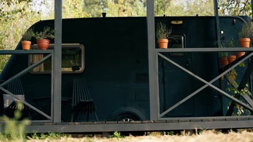 A mobile home with a terrace is located in country glamping site for relaxation and solitude nature