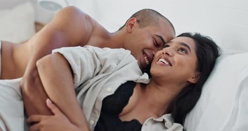 Affectionate Couple Cuddling and Kissing in Bed