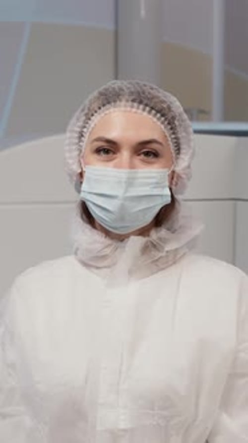 Vertical Portrait of Medical Worker in Sterile Gown in Ophthalmology Clinic