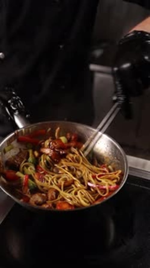 Chef Cooks Stir-fry Noodles in a Restaurant Kitchen
