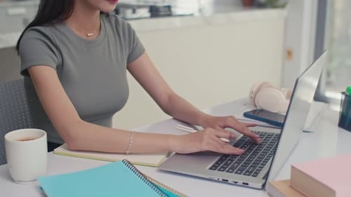 Woman Working at Desk with Laptop and Coffee