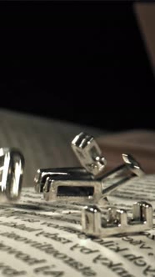 The Fall of Letters on the Pages of the Book Filmed on a Highspeed Camera at 1000 Fps