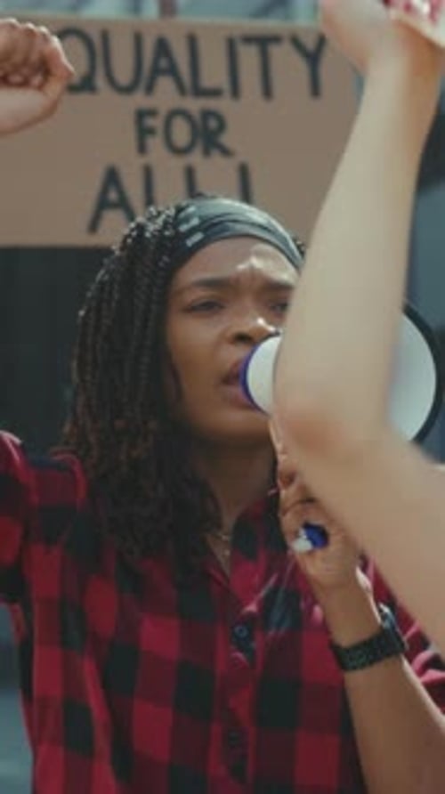 Woman Speaking Into Megaphone at Outdoor Protest