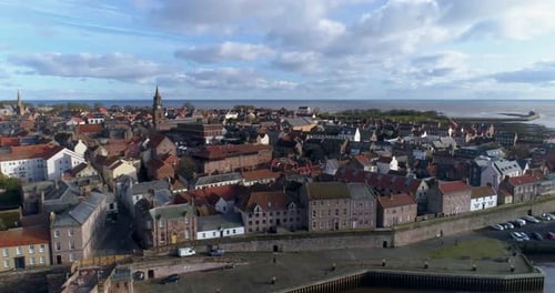 Aerial pan shot of Berwick Upon Tweed town above the river