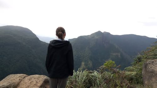 Mujer joven admira la vista en las montañas, Super 240