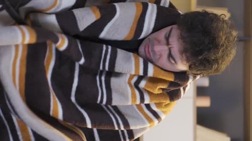 Vertical video of Young man feeling cold.