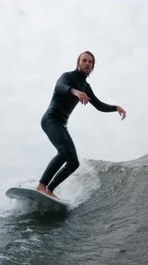 A Captivating Moment Captured in the Ocean As a Surfer Skillfully Rides the Waves Showcasing