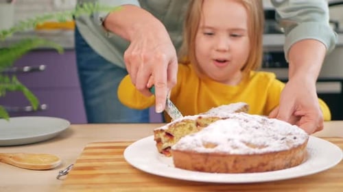 Child Watches Adult Cut Cake at Home