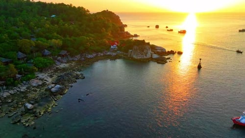 Coastline of tropical island during beautiful sunset from drone view.
