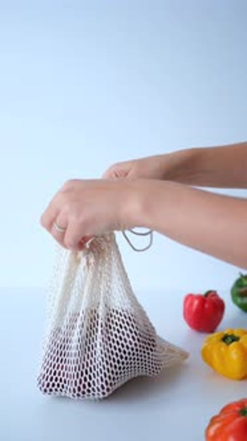 Placing Grapes in Reusable Shopping Bag