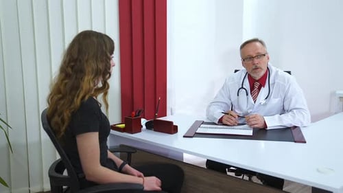 Side view of young female patient on consultation in clinic.