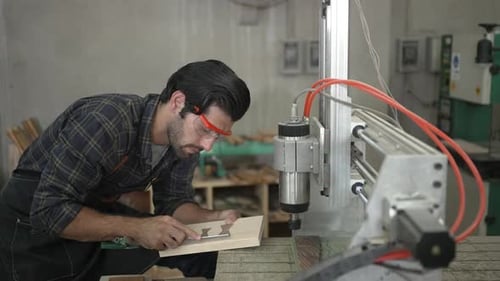 Carpenter is working at workshop.