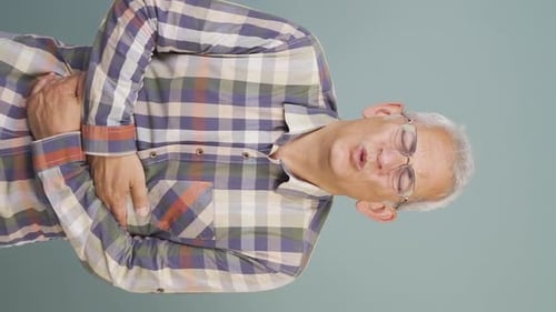 Vertical video of Man experiencing stomachache.