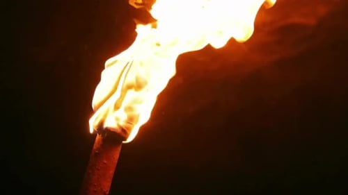 Burning Torch Flame Close-up in the Darkness