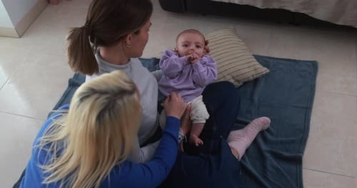 Female Gay Couple Having Tender Moment With Their Baby Son At Home - Family, Lgbt And Love