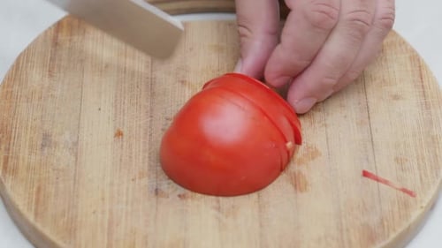 Cutting Tomato Into Small Pieces
