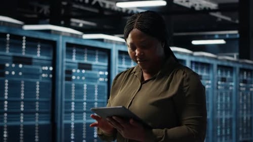 Woman Uses Tablet in Data Center Server Room