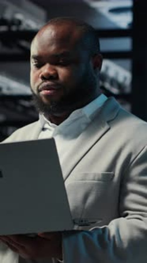 Vertical Video Data Center Computer Scientist Using Laptop to Manage System Stability