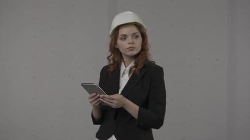 A Woman Architect Conducts an Inspection of the Object and Takes Notes in the Tablet Business Woman