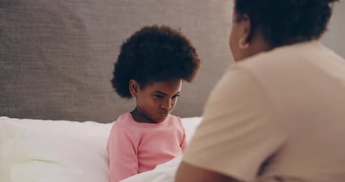 Adult Talking Sternly to Child in Bedroom