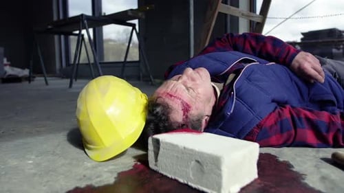Construction Accident Scene: Injured Worker on the Ground