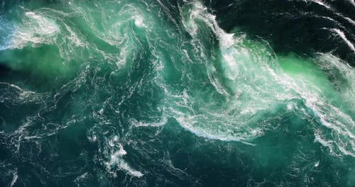 Blue waves of water of the river and the sea meet each other during high tide and low tide.