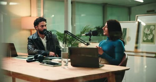 Woman, man and conversation for podcast with microphone, interview and questions for studio guest