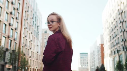 Student Joyfully Walking Between Campus Buildings