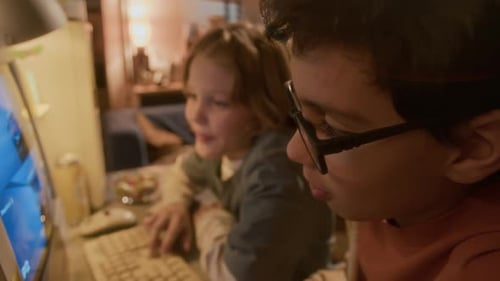 Two Children Playing Computer Game Indoors