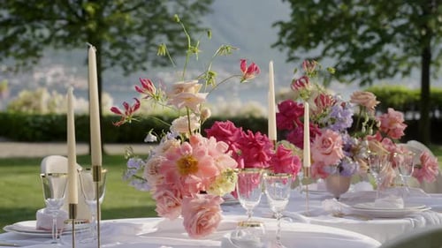 Elegant Outdoor Table Setting with Flowers and Candles