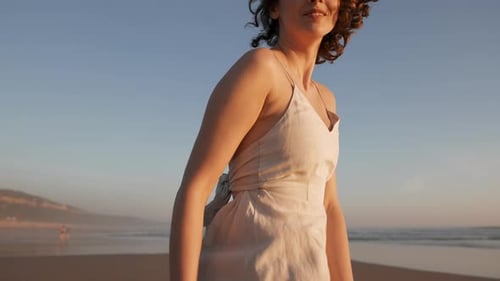 Young Happy Carefree Girl Walks Dancing on Beach
