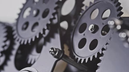 Rotating Black Clock Gears Mechanism Close Up