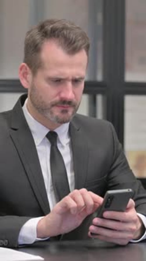 Man Upset by Something He Sees on His Phone