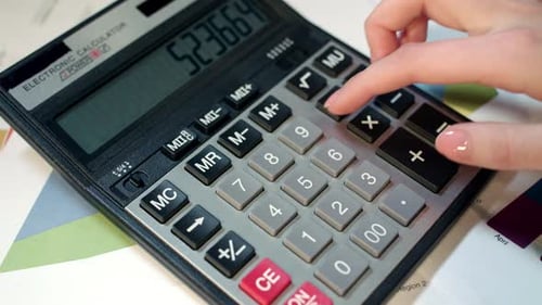 Businesswoman hand using calculator for financial profit calculation at office