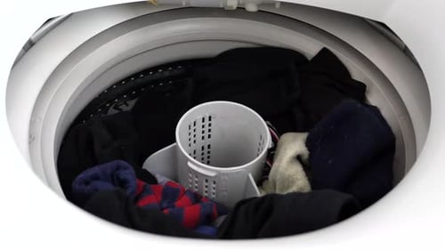 Clothing Placed in Washing Machine with Water