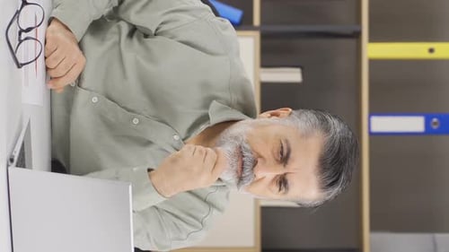 Vertical video of Company manager unhappy and stressed.