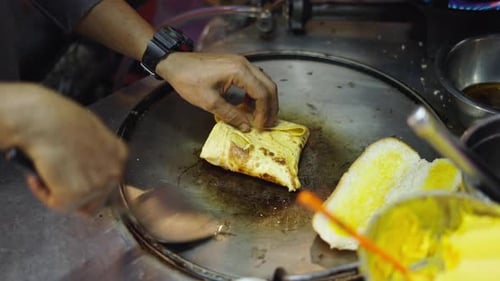 Cooking a Thai Pancake or Rotee in a Street Food Market