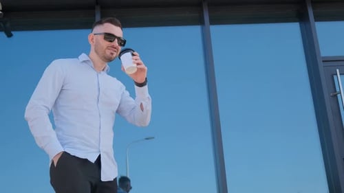 Man Enjoying Coffee Break Outside Modern Building