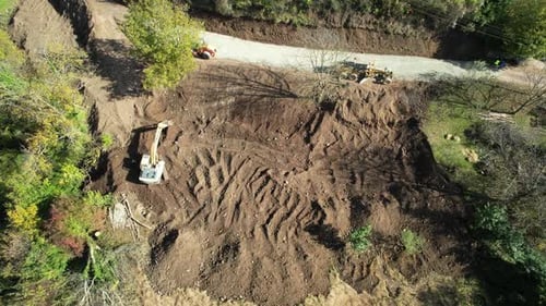 Excavator Digging Soil on Construction Site Aerial View