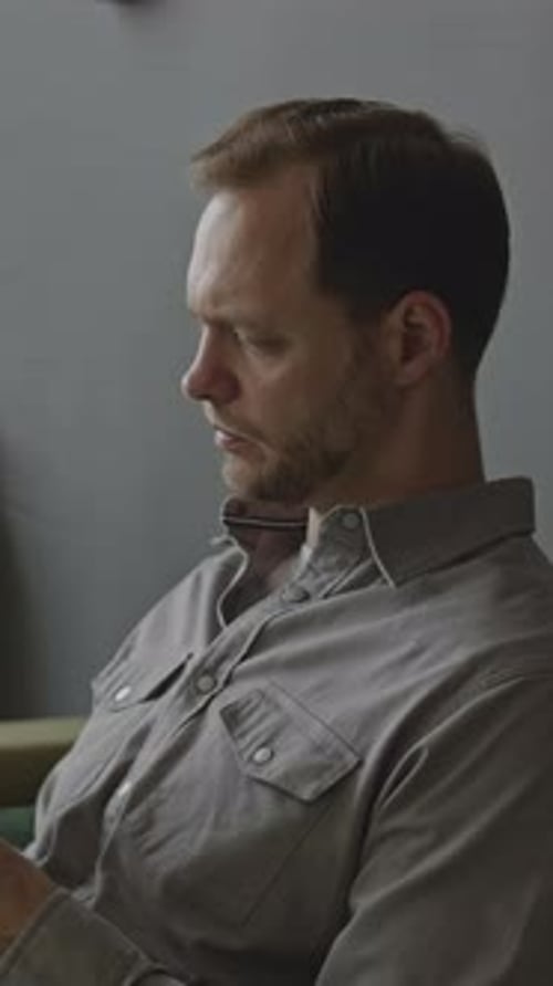 Businessman Reading and Signing Contract in Office