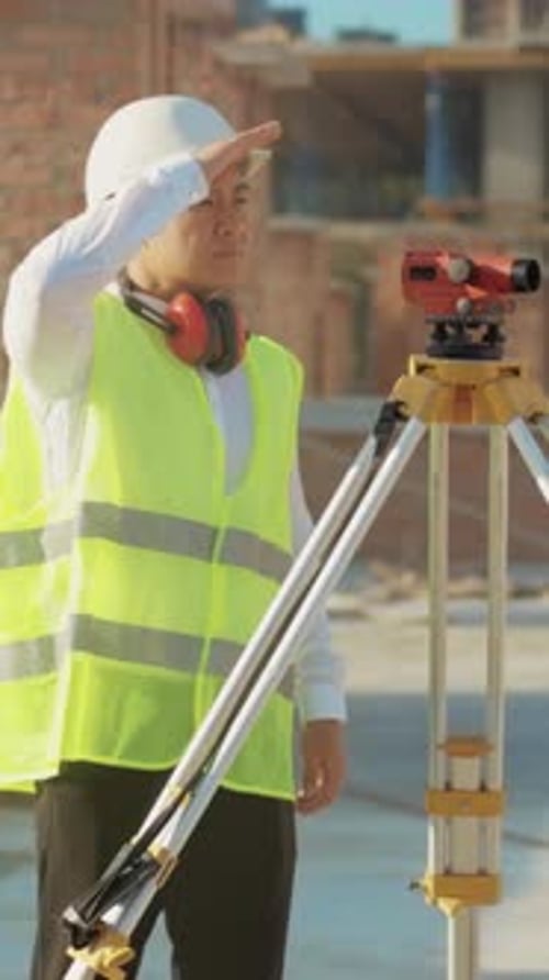 Surveyor Inspects Site Focused Measurement Expert Ensuring Precise Alignment on Busy Construction