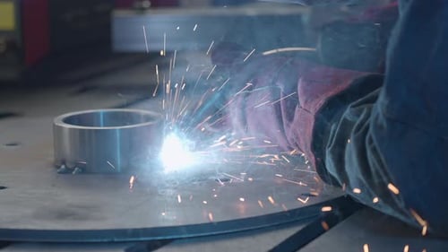Sparks Flying While Welding Metal Cylinder