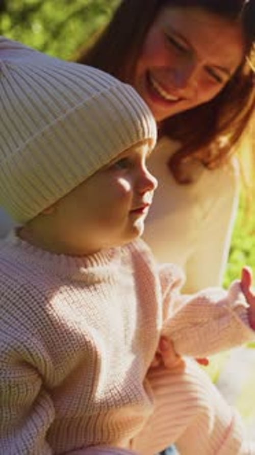 Mother and Child Enjoy a Sunny Day in the Park Sharing Joyful Moments in Nature's Beauty