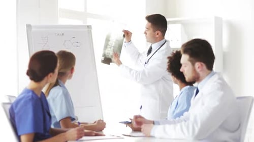 Medical Professionals Discussing X-Ray in a Bright Office